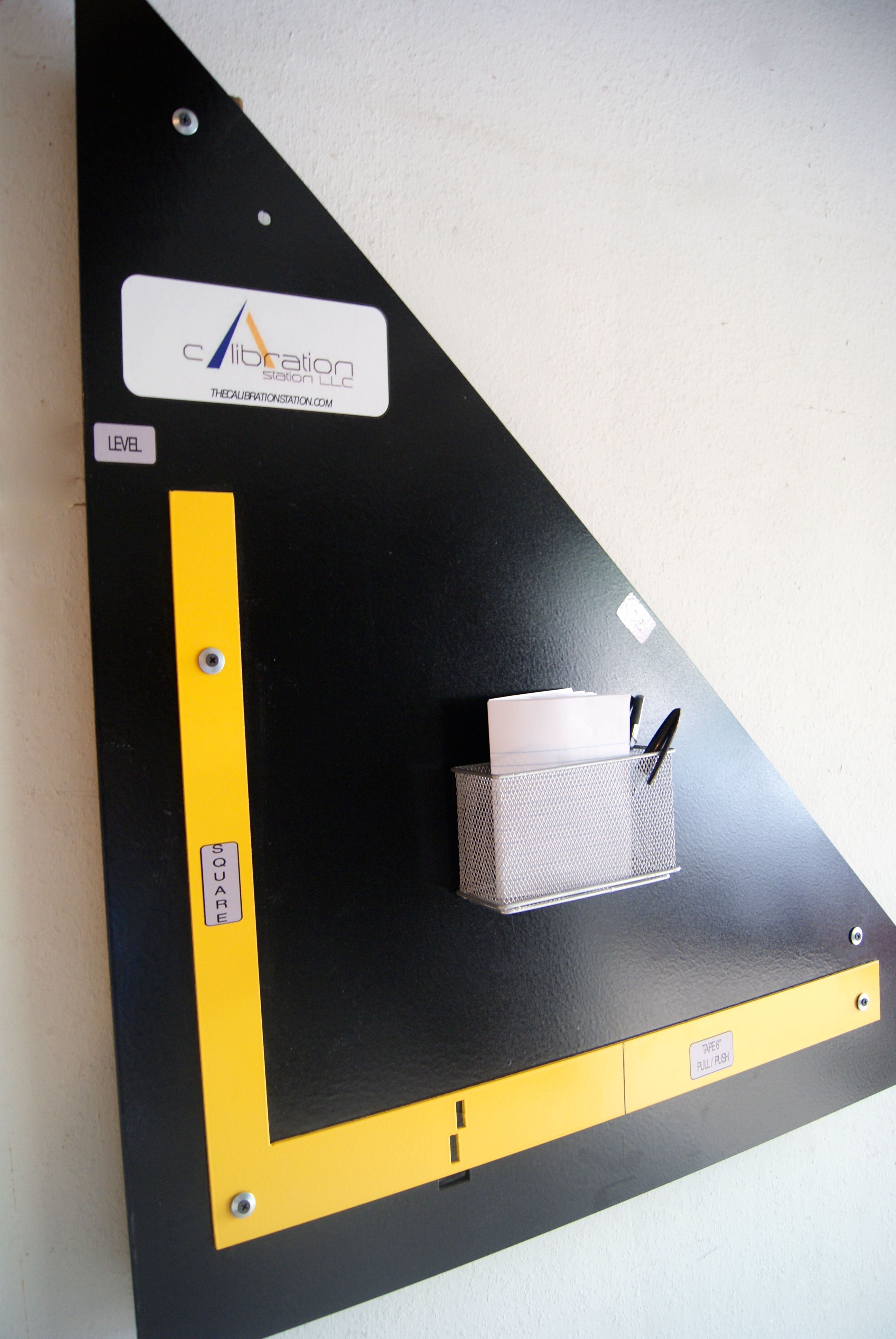 Photo of calibration station angled, calibrates tape measures, squares and levels