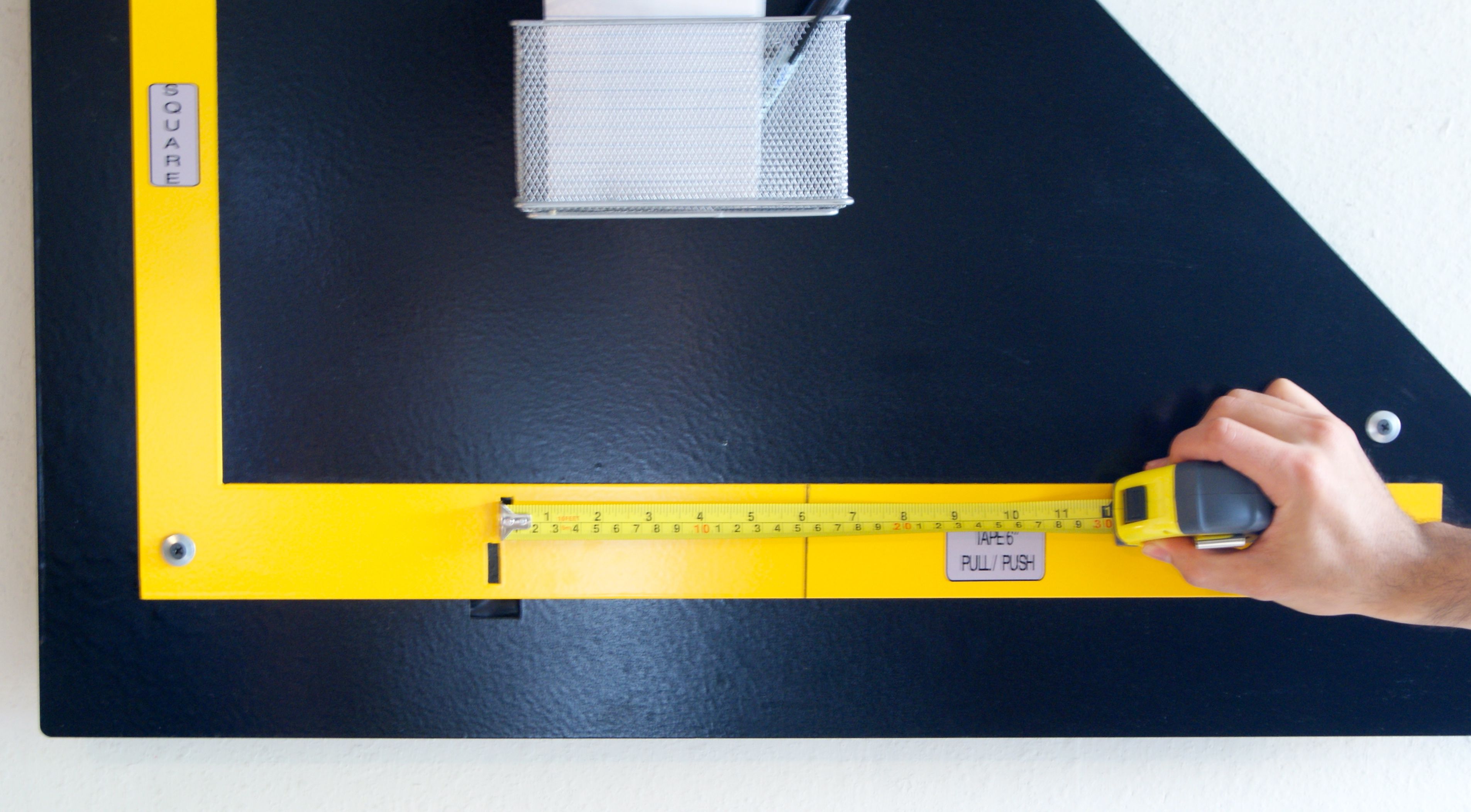 Photo of calibrating by pushing tape measure.